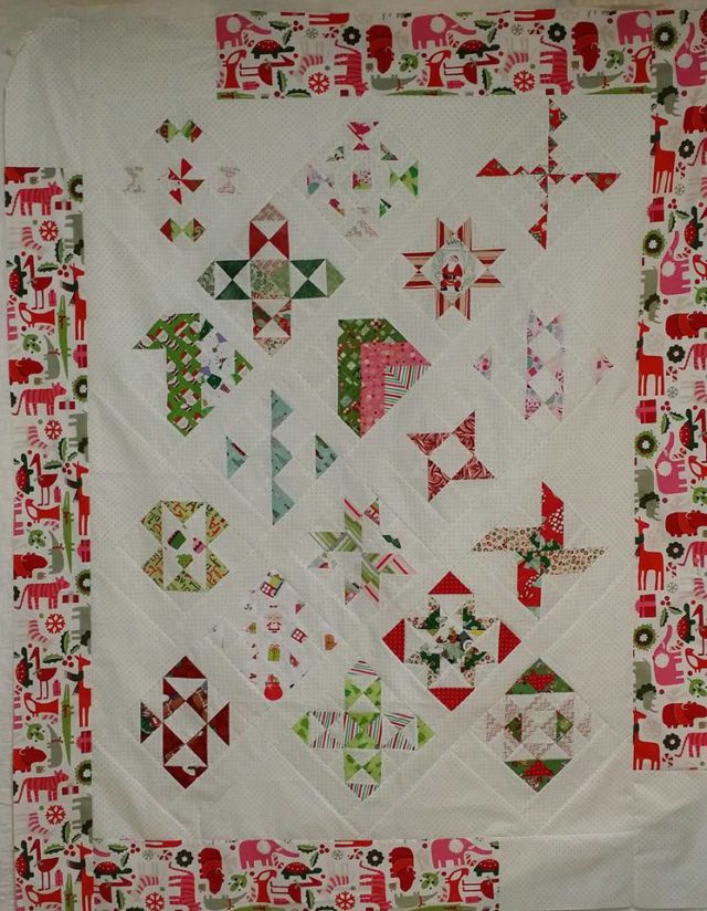 Modern HST Sampler quilt finished with partial borders