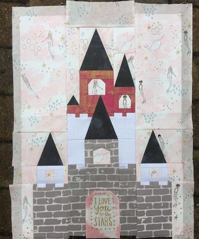 A fairy tale castle quilt block pattern made as an underwater castle complete with mermaid fabric and a fussy cut gate! Pattern available at BlossomHeartQuilts.com