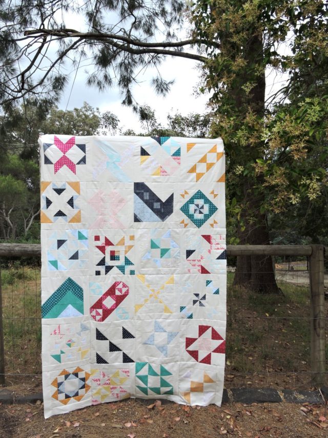 Modern HST Sampler quilt top set in alternate gridwork by BlossomHeartQuilts.com