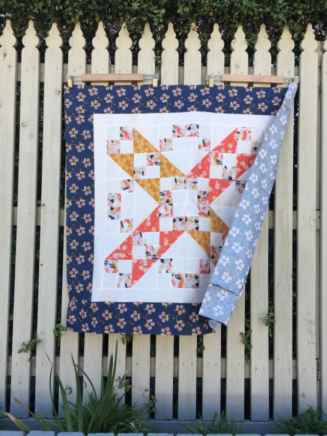 Sweet baby quilt using a Jacobs Ladder quilt pattern in Paper Meadow by JillyP Studio for Dashwood Studio