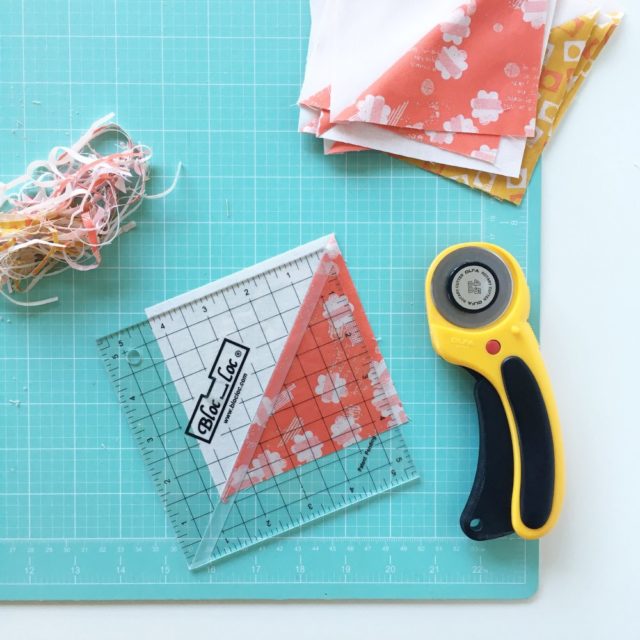 Tips for making half square triangles using a BlocLoc ruler for a Jacobs Ladder baby quilt on BlossomHeartQuilts.com