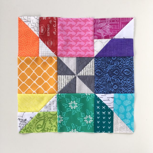 High volume rainbow quilt block using the Bunting pattern by BlossomHeartQuilts.com