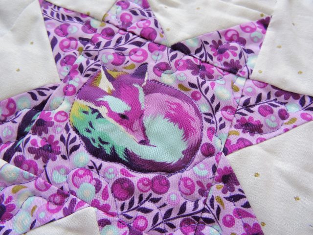 Free motion quilting on Tula Pink Geode quilt by BlossomHeartQuilts.com