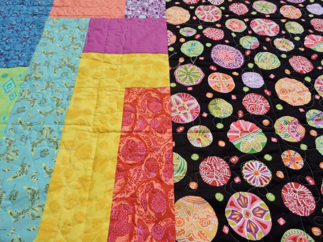 Free motion quilting on scrappy backing