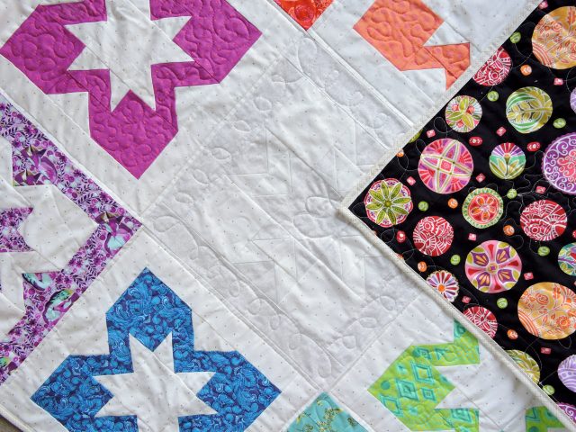 Mary Engelbreit fabric matching Tula Pink rainbow quilt using Geode quilt pattern by BlossomHeartQuilts.com