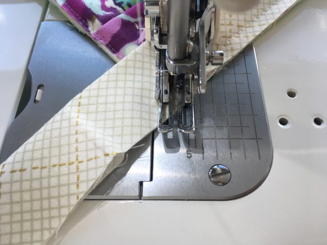 Sewing binding corners to the quilt