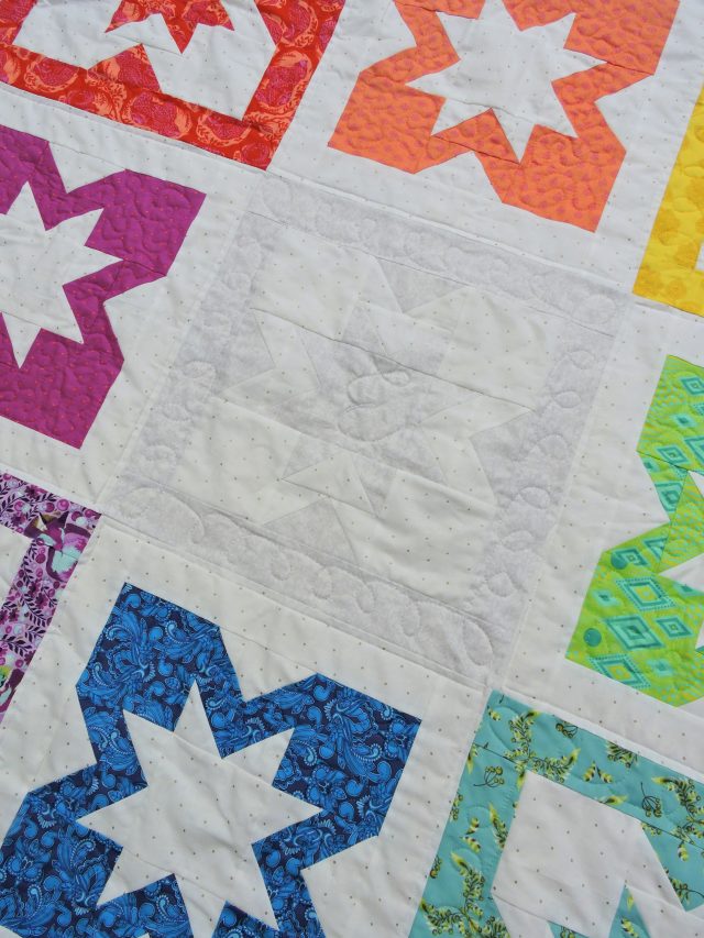 Use monogram free motion quilting on baby quilts by BlossomHeartQuilts.com