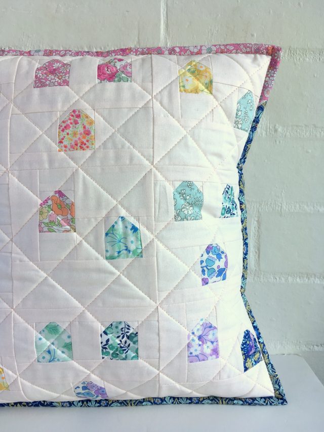 Scrappy Liberty binding on rainbow cushion by BlossomHeartQuilts.com