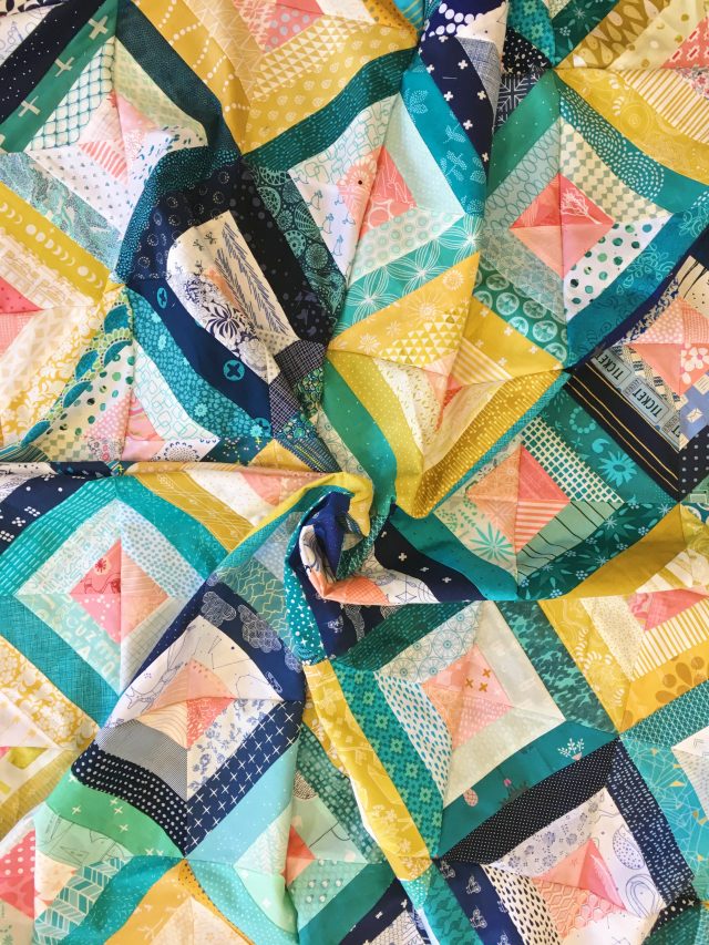 Treasure Hunt quilt in coral, mustard, teal and navy using the free quilt block pattern by BlossomHeartQuilts.com