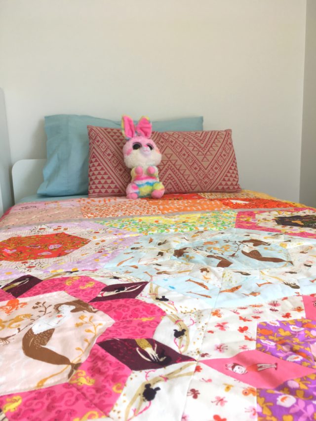 A girl quilt using fussy cut Heather Ross fabric by BlossomHeartQuilts.com