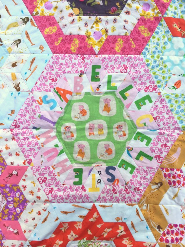 Cherish - an English paper pieced quilt using Heather Ross by BlossomHeartQuilts.com