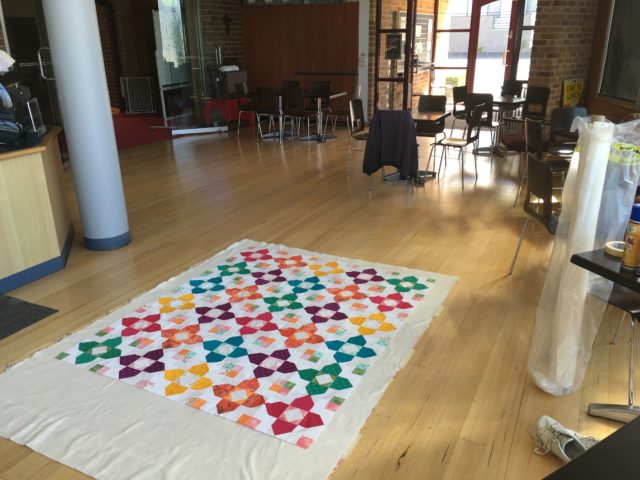 Basting a quilt on a hard floor