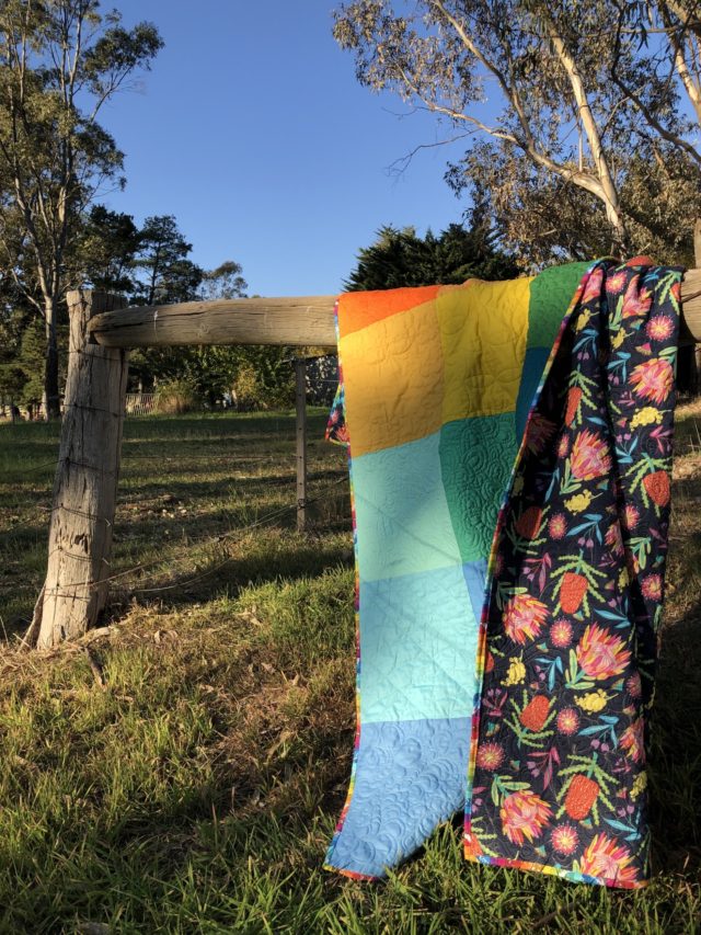 Rainbow quilt with colourful backing