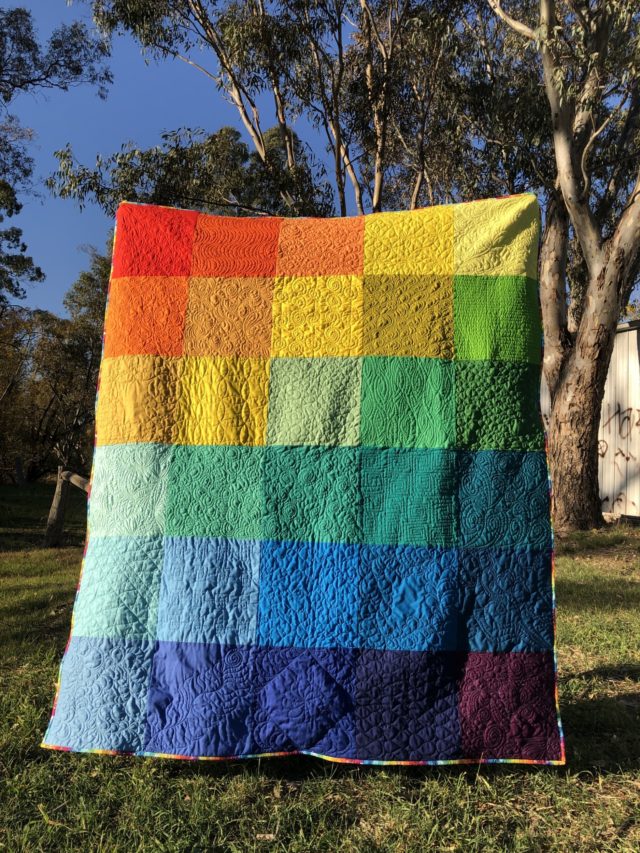 Rainbow quilt with custom free motion quilting